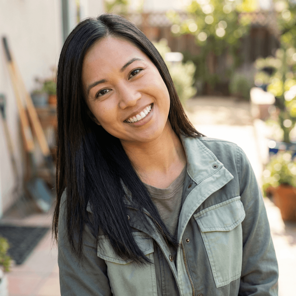 Female retail store owner in her early 40s, East Asian, approachable and competent demeanor appropriate for small business